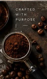 Portafilter filled with fresh coffee grounds and scattered beans